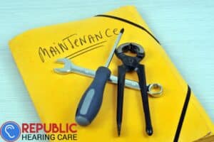 a yellow book that says maintenance with tool sitting on top of it