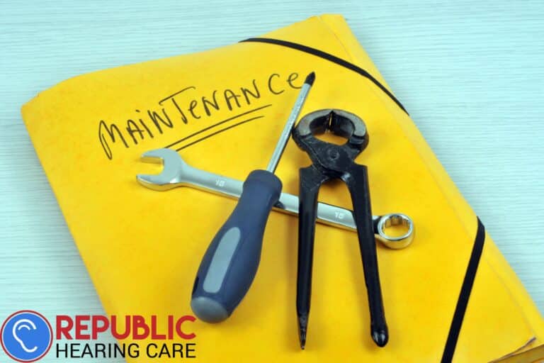a yellow book that says maintenance with tool sitting on top of it