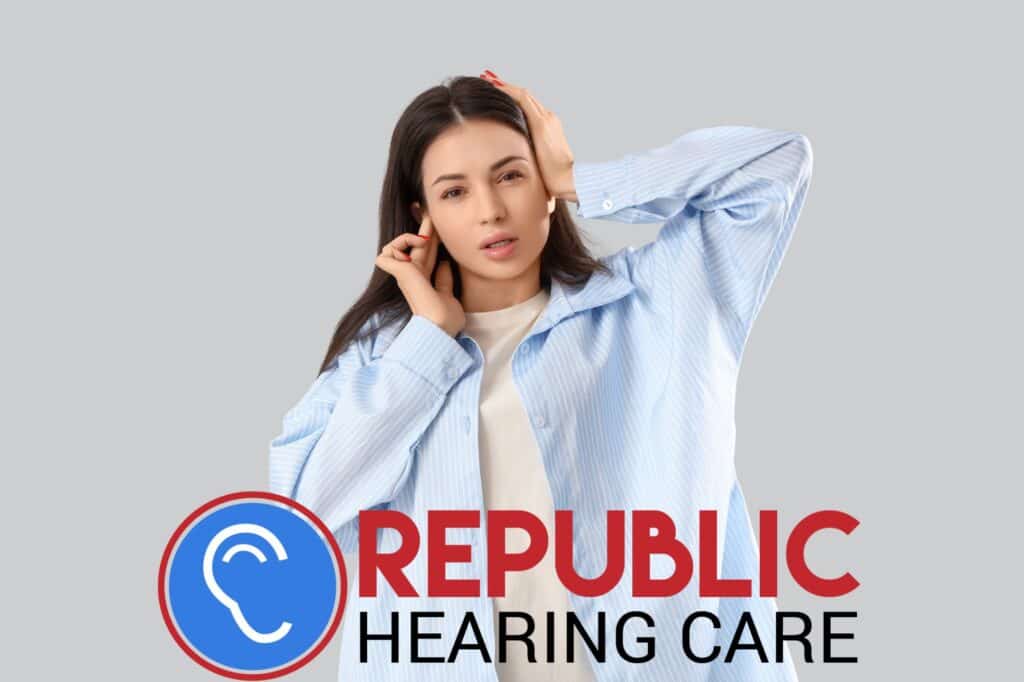 young woman holding her ears in pain