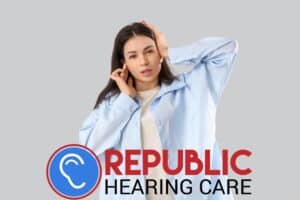 young woman holding her ears in pain