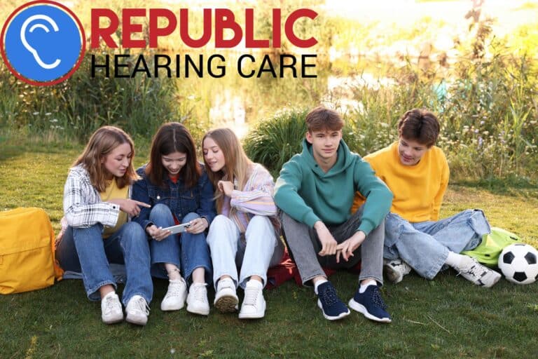 a group of teens sitting by a lake