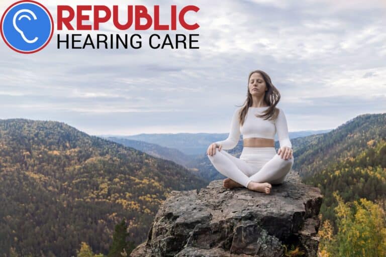 woman meditating on a mountaintop