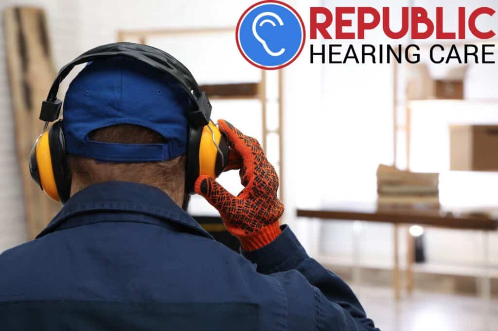 man wearing work gloves and hearing protection